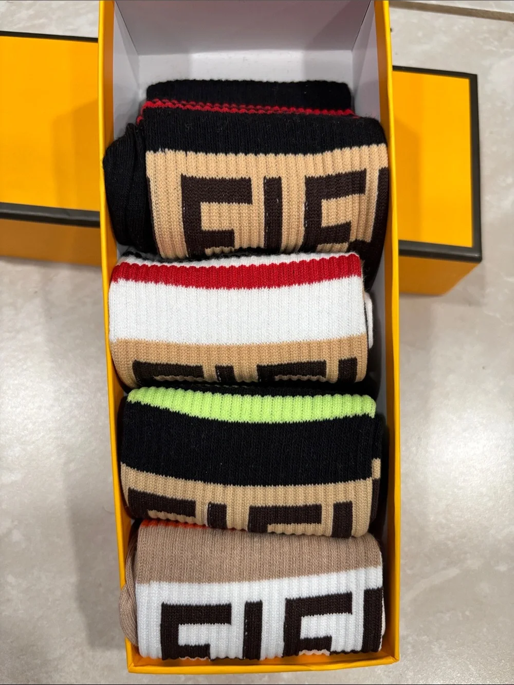 Fendi Bold Yellow Logo Wall Plaque with five pair of socks